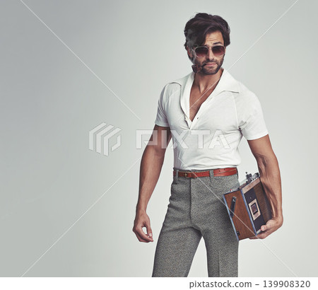 Man, fashion and retro with radio in studio, grey background and smart clothes with elegant style. Trendsetter, vintage and fashionable with old school with pipe, smoking and classy with confidence. Man, fashion and retro with radio in studio, grey background and smart clothes with elegant style. Trendsetter, vintage and fashionable with old school with pipe, smoking and classy with confidence. 139908320