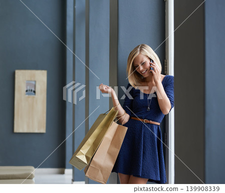Smile, phone call and woman with shopping bags for communication by window in mall or boutique. Happy, cellphone and young female person with style on mobile conversation in retail store for fashion. 139908339