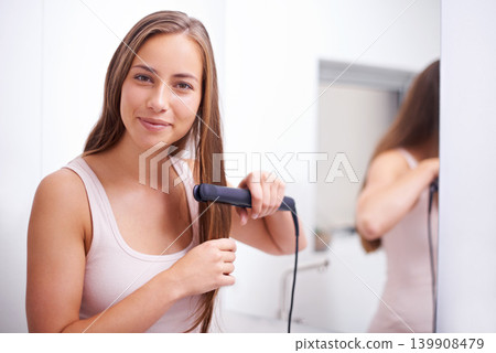 Hair care, portrait and woman with straightener in bathroom for salon, cosmetic and conditioner treatment. Beauty, smile and female person with healthy hairstyle routine with flat iron at home. Hair care, portrait and woman with straightener in bathroom for salon, cosmetic and conditioner treatment. Beauty, smile and female person with healthy hairstyle routine with flat iron at home. 139908479