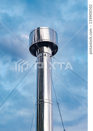 metal round chimney at sky background metal round chimney at sky background 139908502