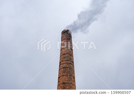 smoking industrial brick chimney at sky background smoking industrial brick chimney at sky background 139908507