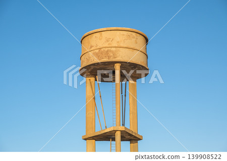 old water tower on blue sky background old water tower on blue sky background 139908522