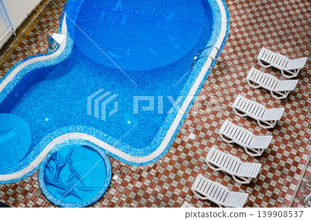 swimming pool with blue water and deck chairs, top view swimming pool with blue water and deck chairs, top view 139908537
