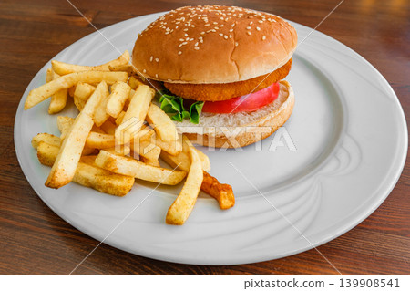 burger and French fries on a plate on the table burger and French fries on a plate on the table 139908541