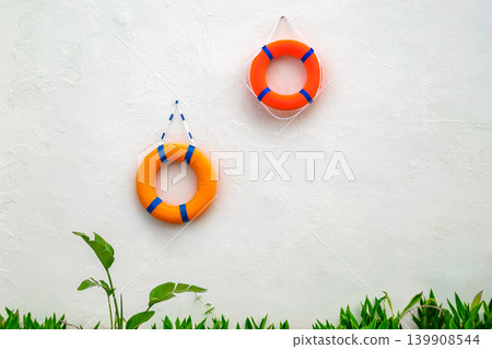 lifebuoys hanging on a white wall lifebuoys hanging on a white wall 139908544