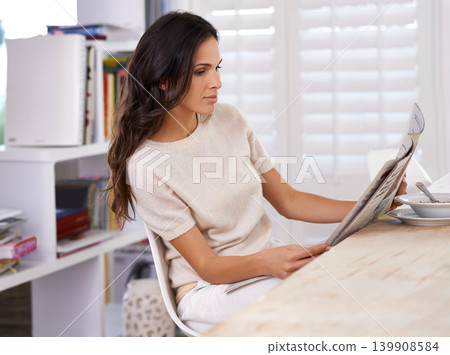 Woman, reading and newspaper at breakfast in home for information, update or global headlines in morning. Person, girl and newsletter for media, finance and article with international story in house Woman, reading and newspaper at breakfast in home for information, update or global headlines in morning. Person, girl and newsletter for media, finance and article with international story in house 139908584