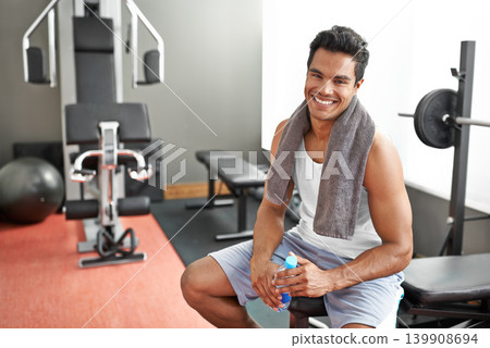 Gym, portrait and happy man with water bottle for recovery after exercise and body building. Healthy, fitness and person relax after workout with liquid hydration for benefits to muscle and wellness Gym, portrait and happy man with water bottle for recovery after exercise and body building. Healthy, fitness and person relax after workout with liquid hydration for benefits to muscle and wellness 139908694