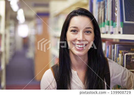 Smile, student and portrait of woman in library for studying at university for test, exam or assignment. Happy, education and confident young female person by books at college campus or academy. 139908729
