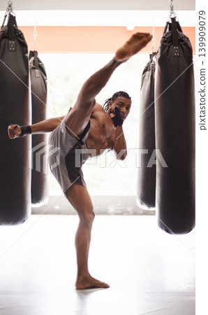 Men, coach and mixed martial arts with training fight, gloves and punch pad for fitness in gym. People, combat and action for mma, boxing or hands for power, workout and exercise for competition Men, coach and mixed martial arts with training fight, gloves and punch pad for fitness in gym. People, combat and action for mma, boxing or hands for power, workout and exercise for competition 139909079