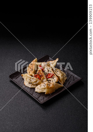Gyoza, Chinese or Japanese meat dumplings, is an Asian food with hot peppers. Gyoza with meat 139909153