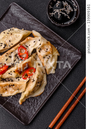 Gyoza, Chinese or Japanese meat dumplings, is an Asian food with hot peppers. Gyoza with meat 139909161