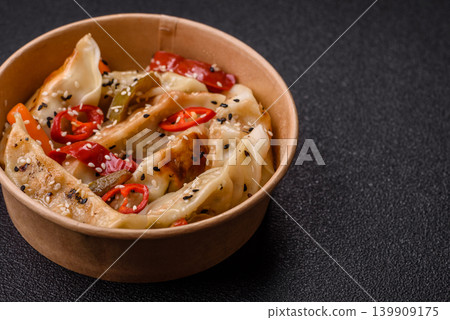 Gyoza, Chinese or Japanese meat dumplings, is an Asian food with hot peppers. Gyoza with meat Gyoza, Chinese or Japanese meat dumplings, is an Asian food with hot peppers. Gyoza with meat 139909175