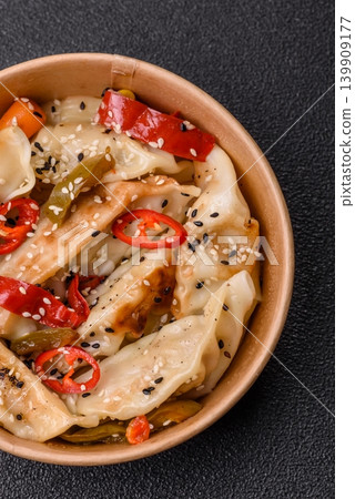 Gyoza, Chinese or Japanese meat dumplings, is an Asian food with hot peppers. Gyoza with meat Gyoza, Chinese or Japanese meat dumplings, is an Asian food with hot peppers. Gyoza with meat 139909177