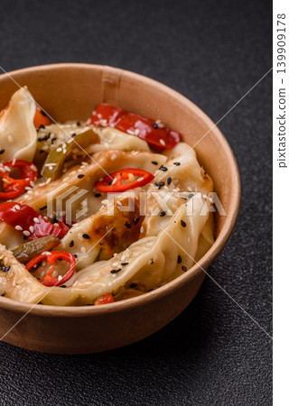 Gyoza, Chinese or Japanese meat dumplings, is an Asian food with hot peppers. Gyoza with meat 139909178