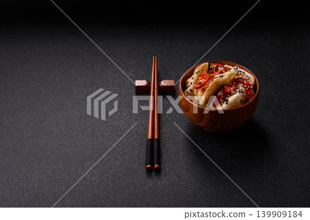 Gyoza, Chinese or Japanese meat dumplings, is an Asian food with hot peppers. Gyoza with meat Gyoza, Chinese or Japanese meat dumplings, is an Asian food with hot peppers. Gyoza with meat 139909184