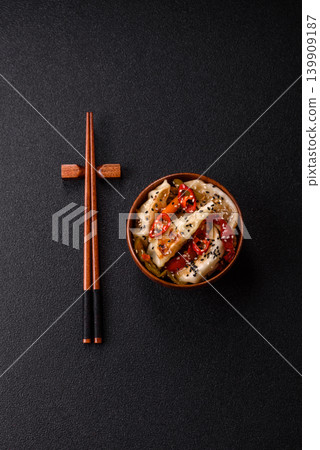 Gyoza, Chinese or Japanese meat dumplings, is an Asian food with hot peppers. Gyoza with meat Gyoza, Chinese or Japanese meat dumplings, is an Asian food with hot peppers. Gyoza with meat 139909187