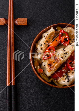 Gyoza, Chinese or Japanese meat dumplings, is an Asian food with hot peppers. Gyoza with meat 139909191