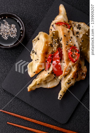 Gyoza, Chinese or Japanese meat dumplings, is an Asian food with hot peppers. Gyoza with meat 139909207