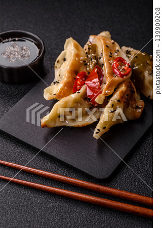 Gyoza, Chinese or Japanese meat dumplings, is an Asian food with hot peppers. Gyoza with meat 139909208