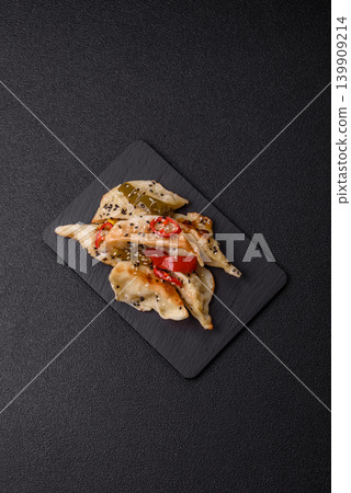 Gyoza, Chinese or Japanese meat dumplings, is an Asian food with hot peppers. Gyoza with meat Gyoza, Chinese or Japanese meat dumplings, is an Asian food with hot peppers. Gyoza with meat 139909214
