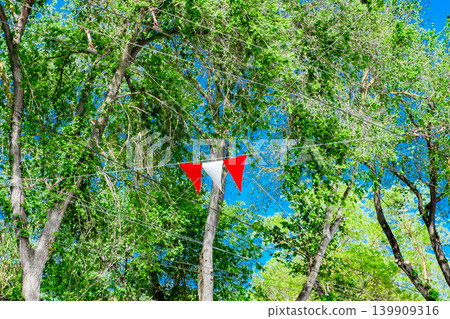 red and white flags are strung on a rope red and white flags are strung on a rope 139909316