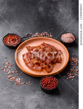 Fried fresh bacon slices with layers of meat or prosciutto with salt and spices. Fried bacon Fried fresh bacon slices with layers of meat or prosciutto with salt and spices. Fried bacon 139909847