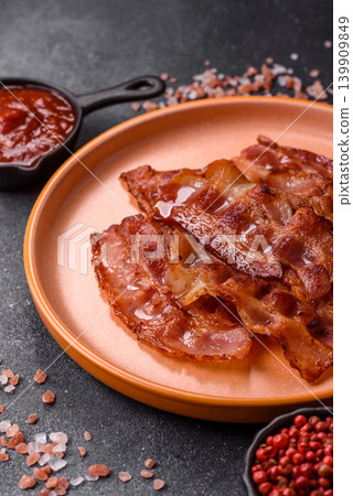 Fried fresh bacon slices with layers of meat or prosciutto with salt and spices. Fried bacon Fried fresh bacon slices with layers of meat or prosciutto with salt and spices. Fried bacon 139909849