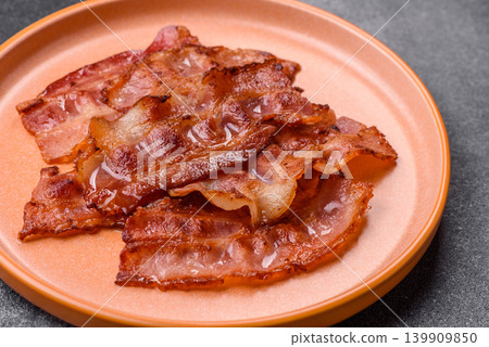 Fried fresh bacon slices with layers of meat or prosciutto with salt and spices. Fried bacon Fried fresh bacon slices with layers of meat or prosciutto with salt and spices. Fried bacon 139909850