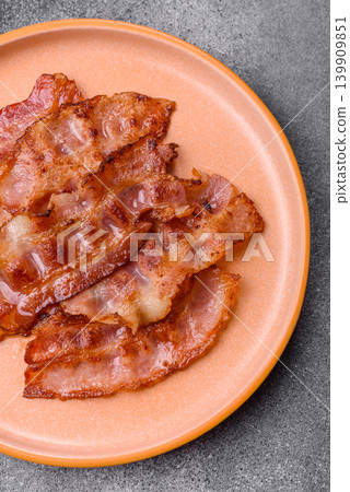 Fried fresh bacon slices with layers of meat or prosciutto with salt and spices. Fried bacon Fried fresh bacon slices with layers of meat or prosciutto with salt and spices. Fried bacon 139909851