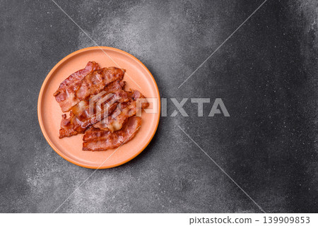 Fried fresh bacon slices with layers of meat or prosciutto with salt and spices. Fried bacon Fried fresh bacon slices with layers of meat or prosciutto with salt and spices. Fried bacon 139909853