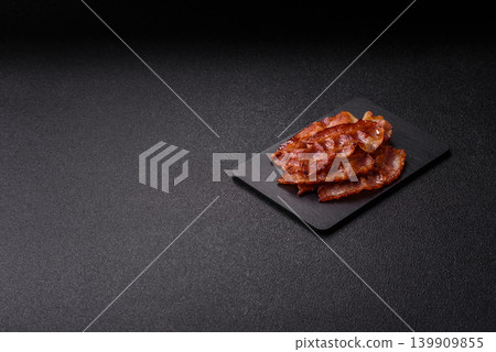 Fried fresh bacon slices with layers of meat or prosciutto with salt and spices. Fried bacon Fried fresh bacon slices with layers of meat or prosciutto with salt and spices. Fried bacon 139909855