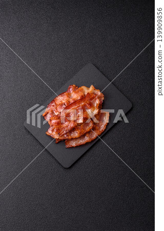 Fried fresh bacon slices with layers of meat or prosciutto with salt and spices. Fried bacon 139909856