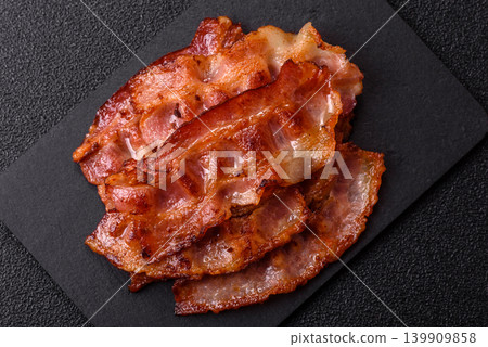 Fried fresh bacon slices with layers of meat or prosciutto with salt and spices. Fried bacon Fried fresh bacon slices with layers of meat or prosciutto with salt and spices. Fried bacon 139909858