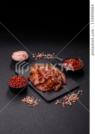 Fried fresh bacon slices with layers of meat or prosciutto with salt and spices. Fried bacon Fried fresh bacon slices with layers of meat or prosciutto with salt and spices. Fried bacon 139909864