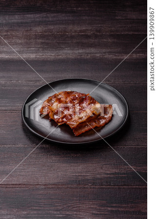 Fried fresh bacon slices with layers of meat or prosciutto with salt and spices. Fried bacon Fried fresh bacon slices with layers of meat or prosciutto with salt and spices. Fried bacon 139909867