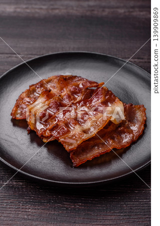 Fried fresh bacon slices with layers of meat or prosciutto with salt and spices. Fried bacon Fried fresh bacon slices with layers of meat or prosciutto with salt and spices. Fried bacon 139909869