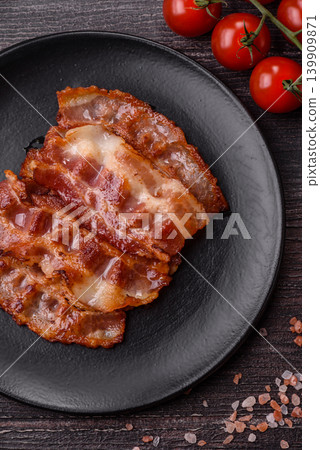 Fried fresh bacon slices with layers of meat or prosciutto with salt and spices. Fried bacon Fried fresh bacon slices with layers of meat or prosciutto with salt and spices. Fried bacon 139909871