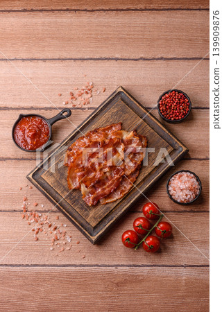 Fried fresh bacon slices with layers of meat or prosciutto with salt and spices. Fried bacon Fried fresh bacon slices with layers of meat or prosciutto with salt and spices. Fried bacon 139909876