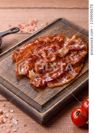 Fried fresh bacon slices with layers of meat or prosciutto with salt and spices. Fried bacon 139909878
