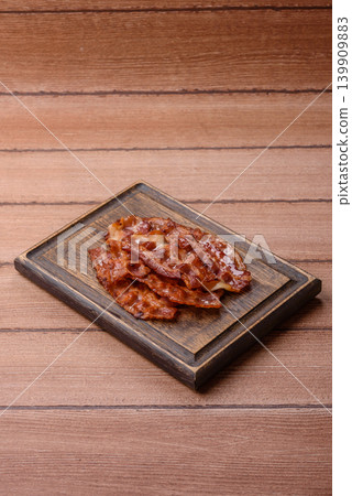 Fried fresh bacon slices with layers of meat or prosciutto with salt and spices. Fried bacon Fried fresh bacon slices with layers of meat or prosciutto with salt and spices. Fried bacon 139909883