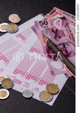 Lottery ticket, Mexican banknotes, and a pen, chance to win big, gambling. Lottery ticket 139910097