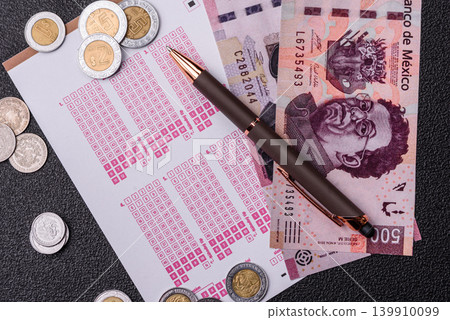 Lottery ticket, Mexican banknotes, and a pen, chance to win big, gambling. Lottery ticket 139910099