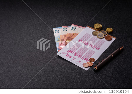 Lottery ticket, banknotes, and a pen, a chance to win big, gambling. Lottery ticket Lottery ticket, banknotes, and a pen, a chance to win big, gambling. Lottery ticket 139910104