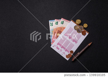 Lottery ticket, banknotes, and a pen, a chance to win big, gambling. Lottery ticket Lottery ticket, banknotes, and a pen, a chance to win big, gambling. Lottery ticket 139910105