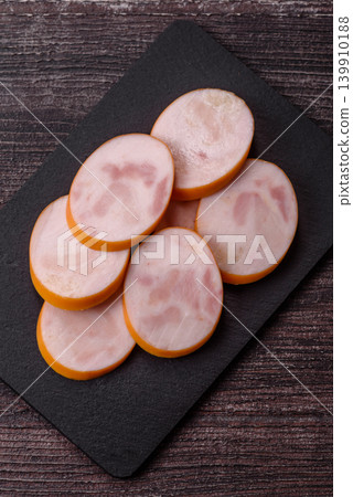 Slices of cooked chicken sausage for sandwiches and antipasto for dinner. Sausage slices 139910188