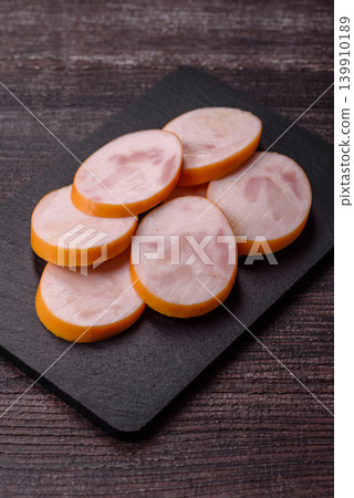 Slices of cooked chicken sausage for sandwiches and antipasto for dinner. Sausage slices 139910189