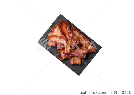 Fried fresh bacon slices with layers of meat or prosciutto prepared for breakfast. Fried bacon Fried fresh bacon slices with layers of meat or prosciutto prepared for breakfast. Fried bacon 139910198