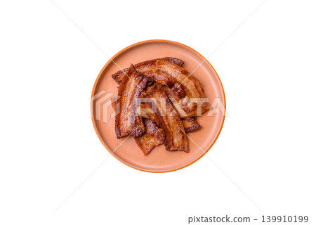 Fried fresh bacon slices with layers of meat or prosciutto prepared for breakfast. Fried bacon Fried fresh bacon slices with layers of meat or prosciutto prepared for breakfast. Fried bacon 139910199