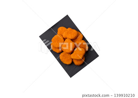 Fried chicken nuggets with sauce, salt, and spices, fast food, unhealthy food. Chicken nuggets Fried chicken nuggets with sauce, salt, and spices, fast food, unhealthy food. Chicken nuggets 139910210