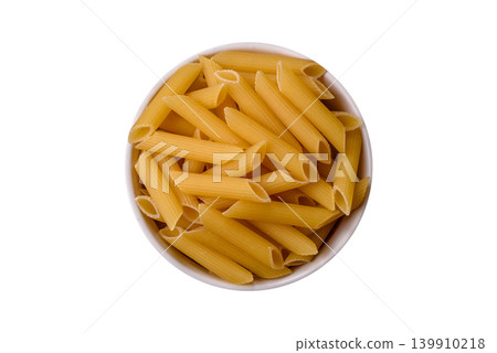 Italian uncooked dry penne regate pasta ready for cooking. Dry penne pasta Italian uncooked dry penne regate pasta ready for cooking. Dry penne pasta 139910218